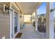 Front porch with black door, white columns, and a bicycle at 1493 Nautical Chart Dr, Charleston, SC 29414