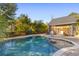 Refreshing freeform pool, brick patio, and backyard oasis at 1493 Nautical Chart Dr, Charleston, SC 29414