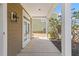 Side porch showing double French doors that open to a covered patio and a view of the landscaped backyard and nearby home at 1493 Nautical Chart Dr, Charleston, SC 29414