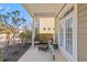 Covered front porch features classic furniture and decor, offering a cozy outdoor seating area near the French doors at 1493 Nautical Chart Dr, Charleston, SC 29414