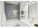 Modern bathroom with gray tile shower and white vanity at 17 H St, Charleston, SC 29403
