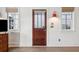 Inviting entryway with hardwood floors, a wood door, and stylish wall sconces at 17 H St, Charleston, SC 29403