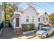 Charming white cottage with a red roof and porch at 17 H St, Charleston, SC 29403