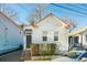 Charming white cottage with a red roof, brick steps, and a well-manicured front yard at 17 H St, Charleston, SC 29403