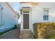 Charming dark brown front door with a brick pathway and well-maintained landscaping at 17 H St, Charleston, SC 29403