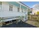 Charming white house with a porch and landscaped yard at 17 H St, Charleston, SC 29403