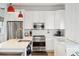 Modern white kitchen with stainless steel appliances and quartz countertops at 17 H St, Charleston, SC 29403