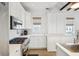 Modern white kitchen with stainless steel appliances and quartz countertops at 17 H St, Charleston, SC 29403