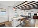 Open concept kitchen and living area with white cabinets and exposed beams at 17 H St, Charleston, SC 29403