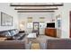 Living room with exposed beams, hardwood floors, comfortable seating, and a large TV at 17 H St, Charleston, SC 29403