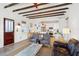 Open living area with kitchen views, exposed beams, and comfortable seating at 17 H St, Charleston, SC 29403