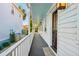 Side porch with white railings and dark grey flooring, offering a view of the backyard at 17 H St, Charleston, SC 29403