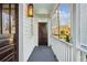Inviting front porch with a light blue ceiling, white railings, and dark gray flooring at 17 H St, Charleston, SC 29403