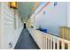 Long side porch with white railings and a view of a neighboring house and yard at 17 H St, Charleston, SC 29403