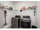 Bright laundry room with washer, dryer, and shelving for storage at 1706 Blue Heron Ave, Moncks Corner, SC 29461