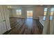 Open living room with vinyl plank flooring and patio access at 185 Carolina Groves Blvd, Moncks Corner, SC 29461