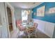 Quaint dining area with glass table, white chairs, and coastal art at 1902 Kerry St, North Charleston, SC 29406