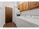 Laundry room with washer, dryer, and upper cabinets at 202 Hunt Club Dr, Summerville, SC 29485