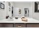 Clean bathroom with dark brown vanity, white countertop, and modern fixtures at 2021 Codorus Ln, Hanahan, SC 29410