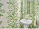 Tropical-themed powder room with pedestal sink and leafy wallpaper at 2021 Codorus Ln, Hanahan, SC 29410