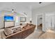 Bright bonus room with a leather couch, TV, and access to a full bath at 2021 Codorus Ln, Hanahan, SC 29410