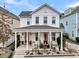 Two-story white house with a gray roof and a covered porch at 2021 Codorus Ln, Hanahan, SC 29410