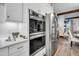 Clean kitchen with double wall oven, stainless steel refrigerator, and white cabinetry at 2021 Codorus Ln, Hanahan, SC 29410