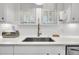 Modern kitchen with white cabinets, a farmhouse sink, and quartz countertops at 2021 Codorus Ln, Hanahan, SC 29410