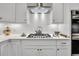 Bright kitchen with white cabinets, gas cooktop, and stainless steel appliances at 2021 Codorus Ln, Hanahan, SC 29410