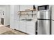 Small kitchenette with white cabinets, stainless steel appliances, and wood shelves at 2021 Codorus Ln, Hanahan, SC 29410