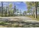 Spacious parking area with tree-lined path at 2021 Codorus Ln, Hanahan, SC 29410