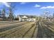 Large backyard with mature trees and a covered patio at 326 Turner Ln, Round O, SC 29474