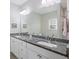Double vanity bathroom with granite countertops and large mirror at 326 Turner Ln, Round O, SC 29474