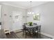 Bright dining area with a round table and four chairs, situated near kitchen and entry at 326 Turner Ln, Round O, SC 29474