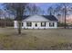 Charming one-story house with white siding, black shutters, and a covered porch at 326 Turner Ln, Round O, SC 29474