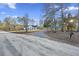 White house with black shutters and long gravel driveway at 326 Turner Ln, Round O, SC 29474
