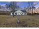 White house with black shutters, bird bath, and trees at 326 Turner Ln, Round O, SC 29474