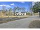 White house with black shutters and gravel driveway at 326 Turner Ln, Round O, SC 29474