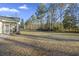 Screened porch overlooks expansive backyard with trees at 326 Turner Ln, Round O, SC 29474