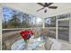Screened porch with seating and ceiling fan, overlooking backyard at 326 Turner Ln, Round O, SC 29474