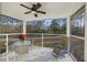 Relaxing screened porch with table, chairs, and ceiling fan at 326 Turner Ln, Round O, SC 29474