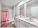 Bathroom with double vanity, tub shower combo, and decorative accents at 343 Lake Ridge Blvd, Summerville, SC 29483