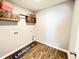 Laundry room with wood-look flooring and stylish shelving at 343 Lake Ridge Blvd, Summerville, SC 29483
