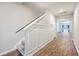 Elegant stairwell with wainscoting and hardwood floors at 343 Lake Ridge Blvd, Summerville, SC 29483