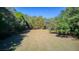 Large, open grass field surrounded by trees at 400 Murray Blvd, Summerville, SC 29483