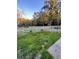 Fenced backyard with grassy area, trees, and a walkway at 406 Chinquapin Dr, Summerville, SC 29485