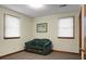 Small bedroom with green couch and two windows at 4118 Dorsey Ave, North Charleston, SC 29405