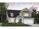 Two-story house with green siding, white trim, and a two-car garage at 468 White Magnolia St, Moncks Corner, SC 29461