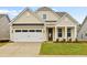 Craftsman style home with beige siding, white garage door, and manicured lawn at 519 Eagleview Dr, Moncks Corner, SC 29461
