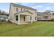 Beige house with covered patio and grassy backyard at 519 Eagleview Dr, Moncks Corner, SC 29461